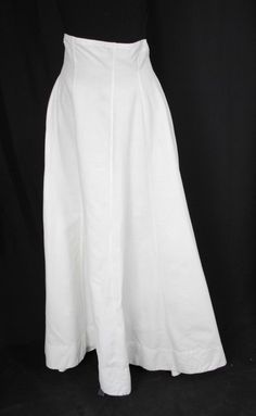 TWO PLAIN LONG LINEN SKIRTS, LATE 1920s This lot contains one linen skirt dating to the late 1920s and early 1930s. The skirt has recently been laundered and pressed. White linen plain skirt with multiple panels to produce fullness. High Waist. Back metal closure using  5 snaps and 6 hook and eyes. Unlabeled. CONDITION Very Good.  No holes, no repairs , has stain on lower back, and has been laundered and pressed. APPROXIMATE MEASUREMENTS Waist: 33", narrows to 31", 3-1/2" high waist Length in front 43" Length at back 46". Every effort has been made to describe our items as accurately as possible including flaws and imperfections to the best of our ability, to give the buyer an accurate description.  Our descriptions are true and accurate to the best of our ability. We try to observe and re Fitted Linen Formal Skirt, Formal Fitted Linen Skirt, Formal Spring Linen Skirt, Formal Linen Skirt For Spring, Fitted Linen Skirt For Formal Occasions, Elegant Full-length Cotton Skirt, Formal Fitted Cotton Skirt, Fitted Vintage Linen Bottoms, Fitted Cotton Daywear Skirt