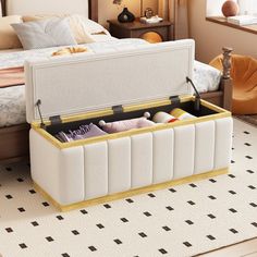 an open suitcase sitting on top of a bed next to a white carpeted floor