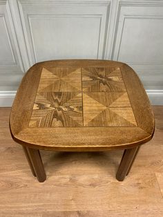 a wooden table sitting on top of a hard wood floor