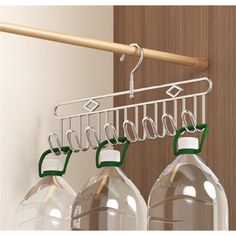 three water bottles hanging from a metal rack