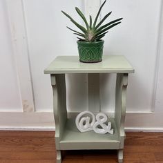 a small table with two towels on it and a potted plant