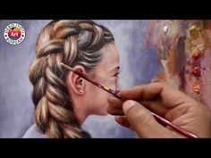 a person is painting a woman's face on a canvas with a paintbrush