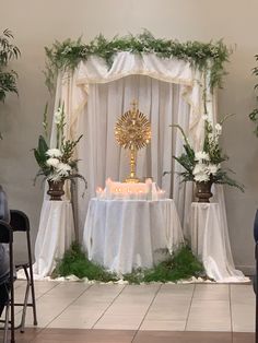 the altar is decorated with greenery and candles for an elegant wedding or special event