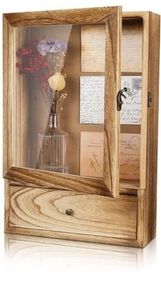 a wooden case with flowers and pictures inside