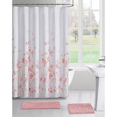 a bathroom with a pink rug and shower curtain