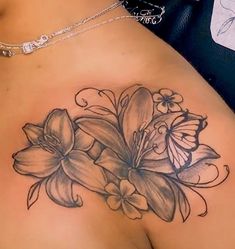 a woman's breast with flowers and butterflies on it