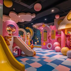 a children's play area with slides, toys and other items in the room