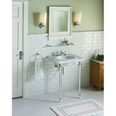 a white bathroom with two sinks and mirrors