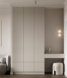 a living room with white walls and wooden flooring next to a gray couch on a hard wood floor