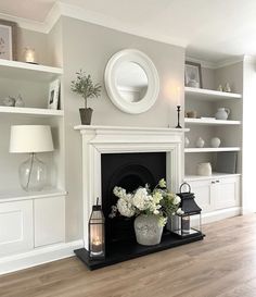 a living room filled with furniture and a fire place next to a white fireplace mantel