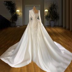 a white wedding dress on display in a room