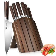 a set of knives and cutting board with fruit on the side