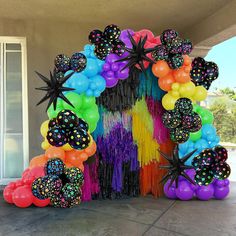 an arch made out of balloons and streamers