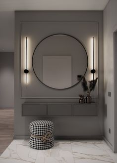 a round mirror on the wall above a bench with a checkered ottoman in front of it