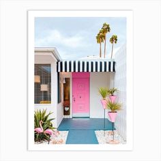 a pink door with black and white striped awning next to two potted plants