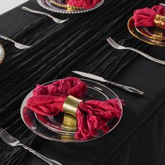 the table is set with silverware and red napkins