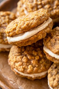 several cookies are stacked on top of each other with frosting in the middle and one cookie has an oatmeal