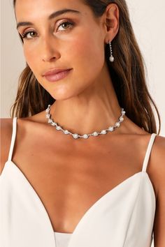 Any occasion that calls for the Lulus Elevated Luxury Silver Rhinestone Pearl Necklace and Earring Set is sure to be a glamorous and memorable event! This stunning jewelry set starts with a dazzling silver necklace that features a series of rhinestone-embellished medallions with shiny faux pearl centers. The matching earrings boast a drop silhouette with slender chains accented with clear rhinestones and the same eye-catching medallions at the ends for a posh finish. Necklace has a lobster clasp closure. Earrings have post backs. Earrings measures 1. 50" long. Necklace measures 12. 5" long with a 6" extender chain. 50% Iron, 35% Stone, 15% Plastic. Imported. Lulus | Elevated Luxury Silver Rhinestone Pearl Necklace and Earring Set. Pearl Necklace And Earring Set, Necklace And Earring Set, Silver Rhinestone, Stunning Jewellery, Clear Rhinestones, Matching Earrings, Long Necklace, Jewelry Set, Faux Pearl