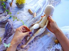 a person is making a doll out of fabric