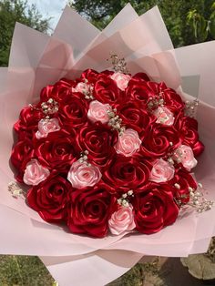 a large bouquet of red and pink roses