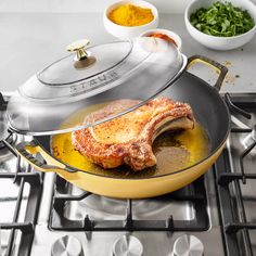 a roasting pan with a piece of meat in it on top of a stove