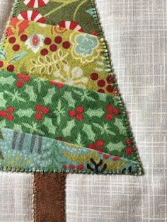 a small patchwork christmas tree on a piece of fabric