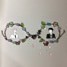 two bracelets that have pictures of people on them and charms attached to each other