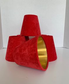 a red cone shaped object sitting on top of a white table