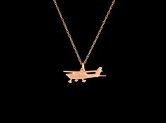 This C172 model Cessna plane pendant is solid 14k rose gold. It measures approximately 30mm wide and 10mm tall, the bail can accommodate up to a 2.5mm chain. It is available with a 16 or 18 inch 1.25mm 14k rose gold rope style chain. This pendant was handmade and hand finished by Daniel Leslie and is his original design. ASK ABOUT CUSTOMIZATION: This Item along with most of my other pieces of jewelry can be customized in terms of metal type, chain length and incorporating gemstones or other mate Airplane Pendant, Cessna Aircraft, Rose Gold Satin, Gold Satin, Feather Pendant, Pure Gold, Satin Finish, Chain Lengths, Chain Length