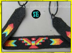 a black beaded necklace with colorful designs on it