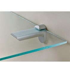 a glass shelf with a toothbrush on top of it and a blue ribbon around the edge