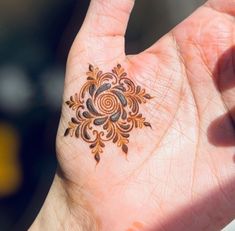 a woman's hand with a small tattoo on it