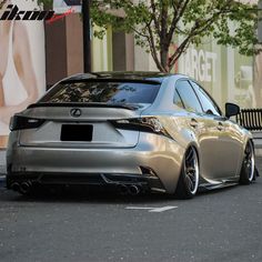 a silver car is parked on the street