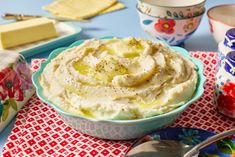 a bowl filled with mashed potatoes on top of a table