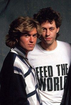 two men standing next to each other in front of a gray background with the words feed the world on it