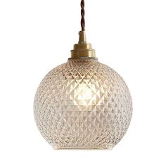 a glass ball light hanging from a ceiling fixture with a brown cord attached to it