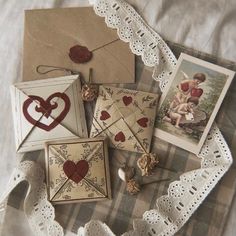 there are many cards on the table with pictures and hearts in them, including one for valentine's day