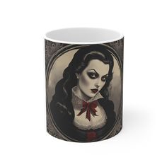 a coffee mug with an image of a woman wearing black and white makeup, holding a red rose in her left hand