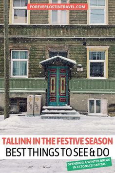 a green door in front of a brown building with snow on the ground and steps leading up to it