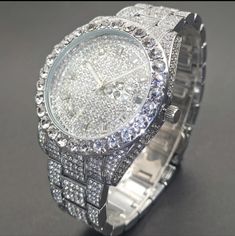 This Watch Is Completely Blinged Out And Heavy. Features: Silverplated Metal Stainless Steel Strap Metal Case Round Dial Shape Is Not Waterproof Quartz Movement Electronic Drive Mode Calendar Simulated Diamonds (Cz) Pointer Display Nice Quality Weight Men Jewelry Silver, Iced Out White Gold Jewelry For Anniversary, Iced Out Round Jewelry For Anniversary, Classic Silver Iced Out Diamond Watch, Iced Out White Gold Jewelry And Watches For Anniversary, Iced Out Round Watches For Anniversary, Iced Out Watches For Anniversary, Silver Diamond Watches With Bling, Luxury Silver Jewelry And Watches With Bling