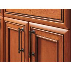 a close up view of the handles and drawers on a kitchen cabinet with wood grained finish