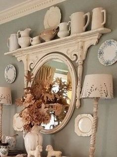 a white dresser topped with lots of plates and vases next to a mirror that says, not me, but like the idea of an upside down dress mirror which then makes a shelf