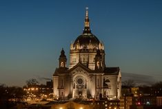 a large cathedral lit up at night in the city