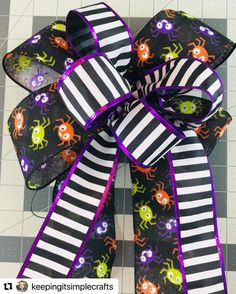 a black and white striped bow with halloween decorations on it