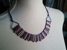 a necklace made out of strips of colored beads on a mannequin neckline