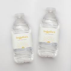 two bottled water bottles sitting next to each other on a white surface with the label inspella's