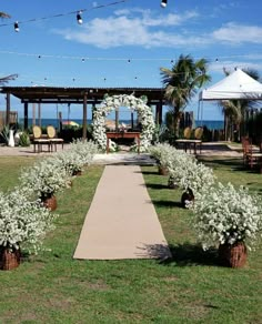 an outdoor wedding setup with white flowers and greenery