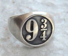 a silver ring with the number nine on it