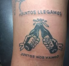 a tattoo with two boxing gloves and the words in latin writing on it's side