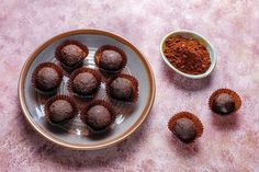 some chocolates are sitting on a plate next to spices